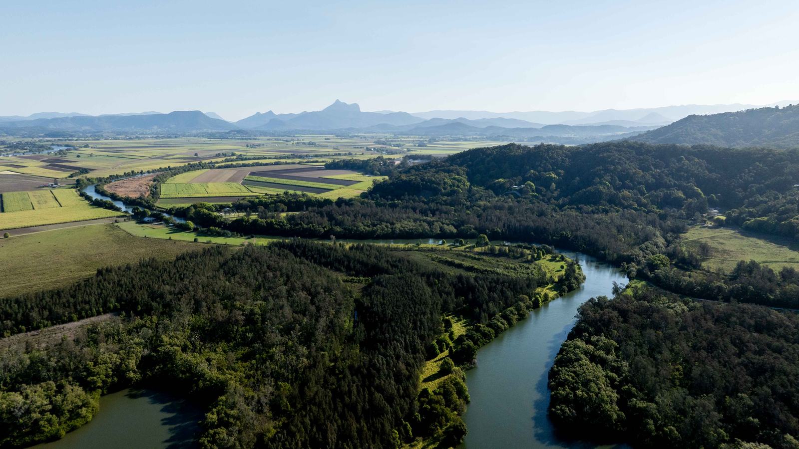 Aerial view of the Tweed River winding through green hinterland near Tumbulgum